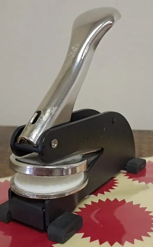 Close-up of a notarial seal embosser used for document authentication in Cape Town